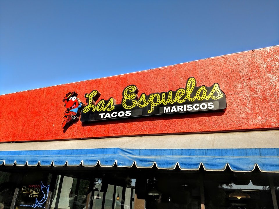 Colorful Mexican restaurant tables and chairs inside.