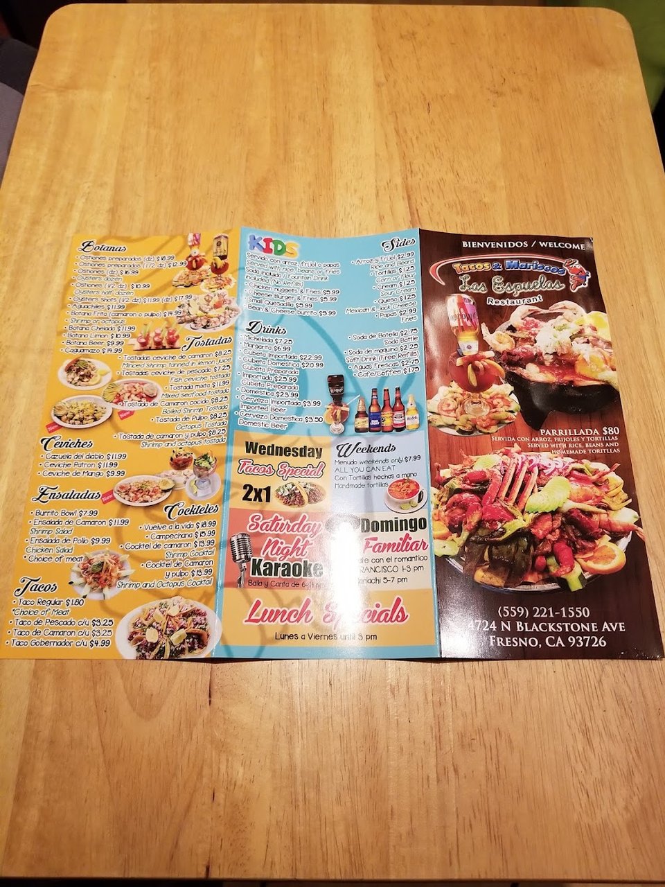Printed menu showing tacos, burritos, and seafood plates.